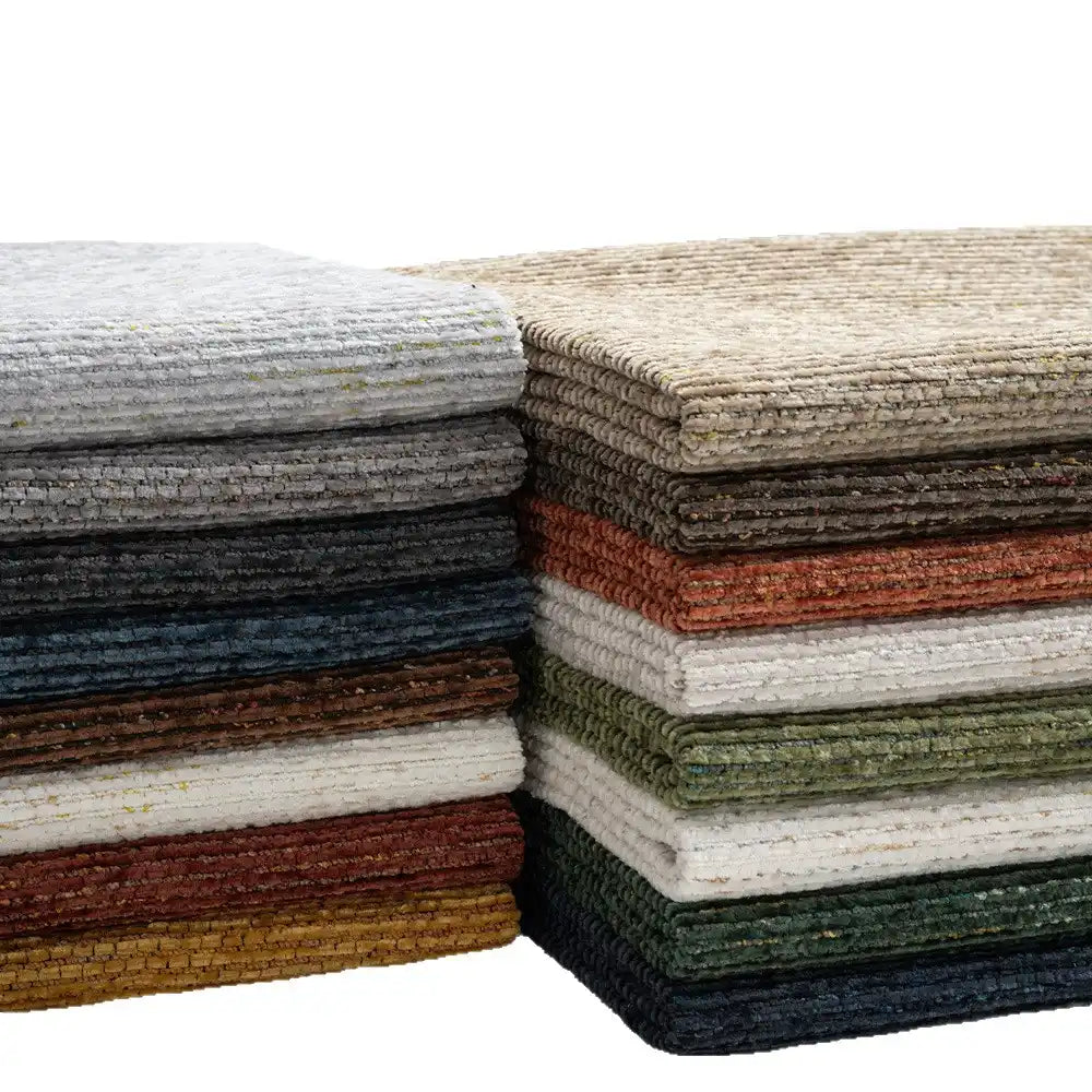 Stacks of Longan Craft Heavy Weight Slub Chenille Fabric by the Yard in gray, beige, blue, green, red, brown, and white are neatly arranged—premium thick polyester chenille material for upholstery fabric projects.