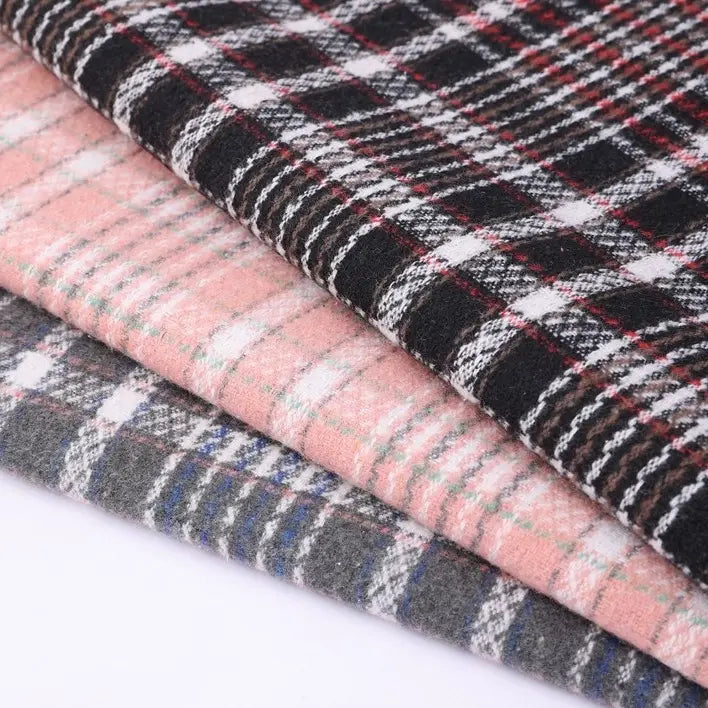 Three folded pieces of Longan Craft Heavyweight Cotton Checked Flannel Fabric By The Yard are stacked on top of each other in black, pink, and gray tones, each featuring a white checkered pattern.