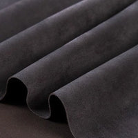 Close-up of Longan Craft Heavyweight Microfiber Faux Suede Fabric by the Yard in dark gray, highlighting its smooth, soft microfiber texture and gentle wavy folds—perfect for DIY clothing projects.