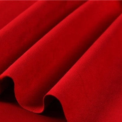 Close-up of heavyweight microfiber faux suede fabric by the yard from Longan Craft, showcasing its smooth, vibrant red brushed microsuede surface with soft folds and gentle shadows for a sense of texture and depth—perfect for DIY clothing projects.