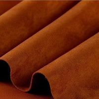 A close-up of folded Heavyweight Microfiber Faux Suede Fabric by the yard from Longan Craft, highlighting its soft brushed microsuede texture and vibrant multicolor tones—perfect for DIY clothing projects.