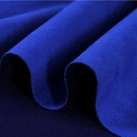Close-up of Longan Craft’s Heavyweight Microfiber Faux Suede Fabric by the Yard in a rich, royal blue, featuring plush folds that showcase its brushed microsuede texture and vibrant color—a luxurious choice for DIY clothing projects or upscale upholstery.