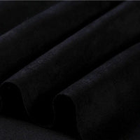 Close-up of black microfiber faux suede fabric by Longan Craft, highlighting its soft, brushed texture arranged in gentle folds that create shadows and lend a rich, luxurious look—evoking the depth and sophistication characteristic of heavyweight microsuede material, ideal for DIY clothing projects.