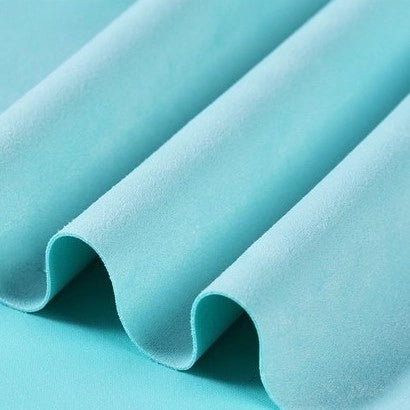 Close-up of Longan Craft’s Heavyweight Microfiber Faux Suede Fabric By The Yard in light blue, featuring a soft, brushed texture. The multicolor microsuede material is arranged in smooth, evenly spaced folds, creating gentle waves and shadows across the surface—ideal for DIY clothing projects.