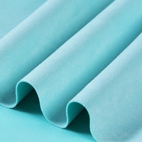 Close-up of Longan Craft’s Heavyweight Microfiber Faux Suede Fabric By The Yard in light blue, featuring a soft, brushed texture. The multicolor microsuede material is arranged in smooth, evenly spaced folds, creating gentle waves and shadows across the surface—ideal for DIY clothing projects.