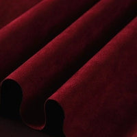 The richly colored, heavyweight Longan Craft Microfiber Faux Suede Fabric By The Yard is draped in soft folds, highlighting its smooth, luxurious brushed microsuede texture—an elegant and sophisticated material ideal for upholstery or DIY clothing projects seeking the beauty of imitation suede.