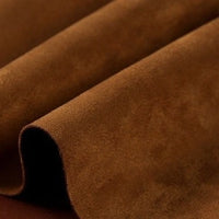 Close-up of Longan Craft Heavyweight Microfiber Faux Suede Fabric by the yard, delicately folded into gentle waves to showcase its multicolor brushed microsuede surface—its ultra-soft texture and vibrant hues make it a perfect choice for stylish upholstery or DIY clothing projects.