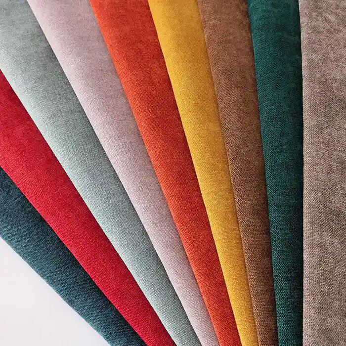A fan of Longan Craft’s Heavyweight Polyester Chenille Fabric swatches in vibrant solid colors, perfect for upholstery, is displayed on a white surface. This soft chenille material is ideal for couches and available by the yard.