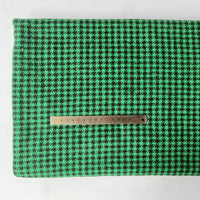 The Longan Craft Houndstooth Mammoth Flannel Fabric By The Yard is shown flat with a metal ruler for scale, highlighting the green and black brushed polyester cotton blend—perfect as a comfy fall flannel textile.