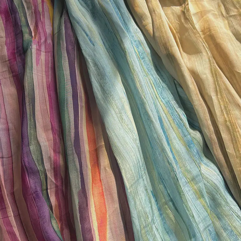 Experience the vibrant elegance of Longan Craft’s Irregular Stripe Printed Ramie Fabric by the yard—a lightweight, breathable ramie material ideal for dressmaking. This sheer fabric features irregular vertical stripes in an array of purple, pink, green, blue, yellow, and orange hues. Soft natural lighting beautifully highlights its graceful folds and airy texture.