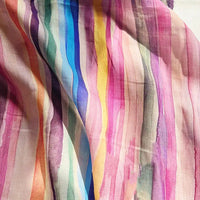 Close-up of Longan Craft’s Irregular Stripe Printed Ramie Fabric by the Yard, a lightweight natural ramie textile featuring vertical watercolor stripes in a range of softly blended colors such as pink, yellow, blue, green, and purple. The flowing artistic pattern makes this printed fabric ideal for dressmaking and creative projects.