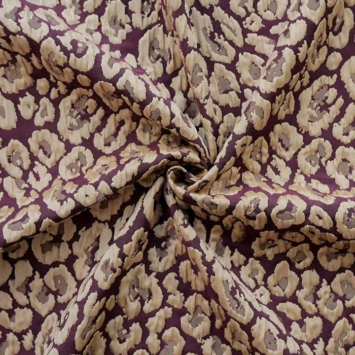 Leopard Embossed Brocade Fabric by Longan Craft features a beige and brown animal print with a wrinkled, circular twist design on rich maroon stretch jacquard—perfect vintage material for dressmaking.