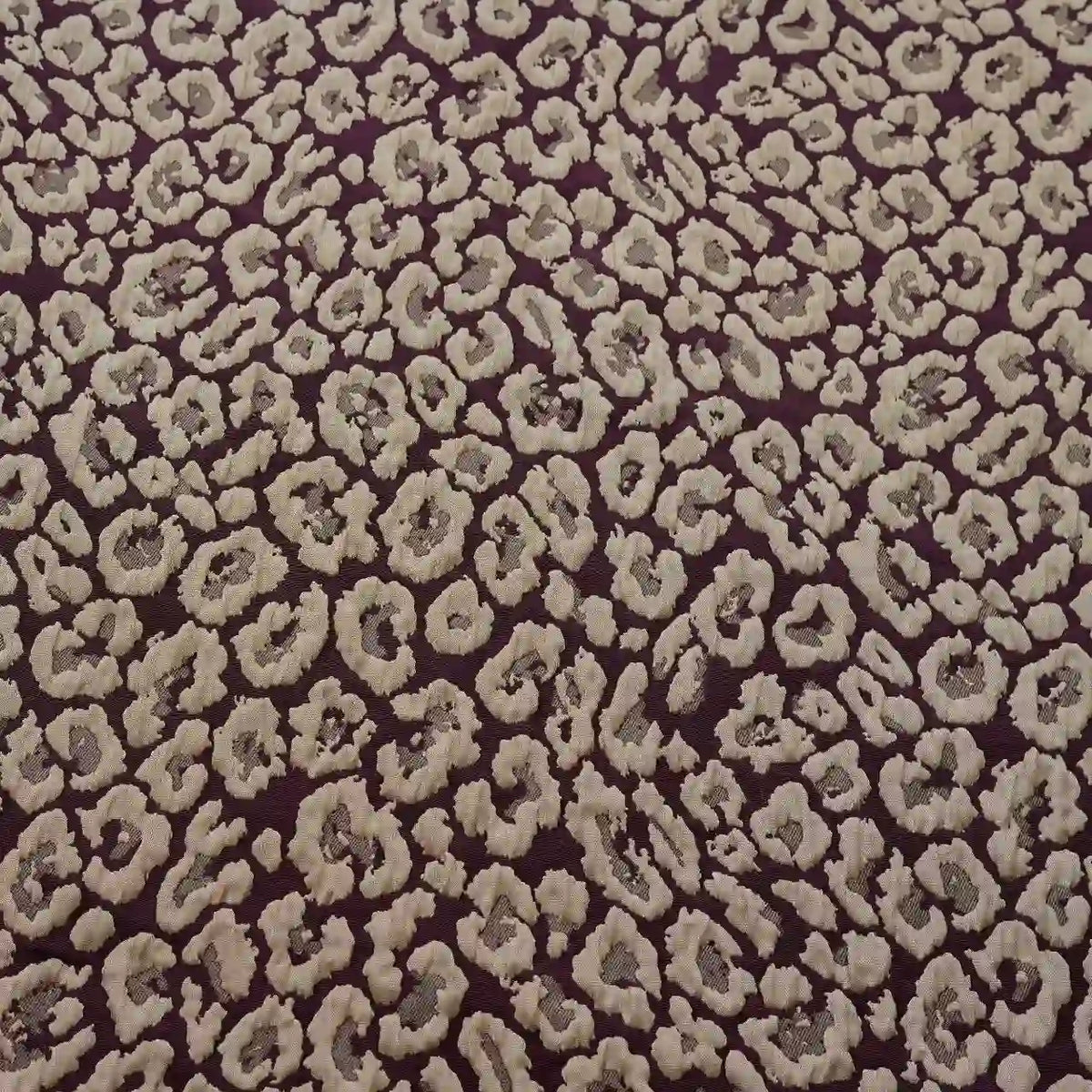 Close-up of Longan Craft Leopard Embossed Brocade Fabric By The Yard, a stretch jacquard with beige and light brown leopard print on dark brown—ideal vintage material for dressmaking with richly textured, organic animal spots.