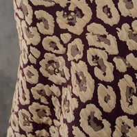Close-up of Longan Craft's Leopard Embossed Brocade Fabric By The Yard—a stretch jacquard brocade with a tan and brown abstract leopard print on dark brown, perfect for stylish, animal-inspired dressmaking projects.