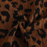 Brown Leopard Jacquard Chenille Fabric by the Yard bunched in the center.