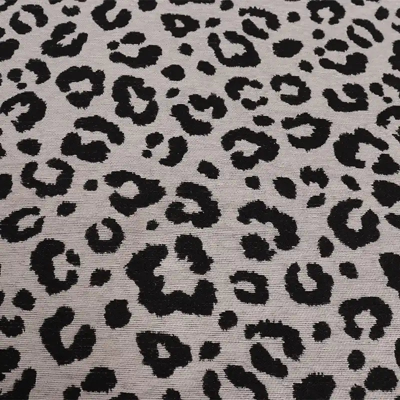 Leopard Jacquard Chenille Fabric By The Yard featuring a textured black animal print pattern on a light gray background.