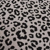 Leopard Jacquard Chenille Fabric By The Yard featuring a textured black animal print pattern on a light gray background.