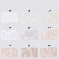Nine Leopard Jacquard Satin fabric swatches by Longan Craft, labeled 1#–9#, display subtle animal prints in shades from white to beige and cream. Multicolor polyester satin is soft, smooth, and ideal for DIY shirts. Arranged in three rows on a light gray background.