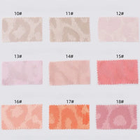 Nine rectangular swatches of Longan Craft's Leopard Jacquard Satin Fabric by the yard, labeled 10#–18#, display pastel hues from beige and pink to coral, arranged in three rows to show subtle multicolor animal patterns.