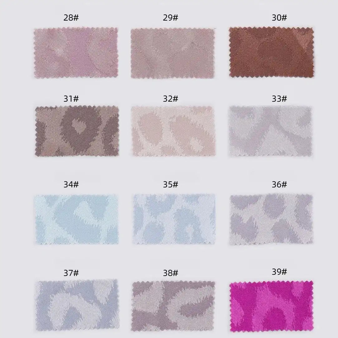 Fourteen Longan Craft Leopard Jacquard Satin fabric swatches in multicolor animal prints, numbered 28# to 39#, are arranged in two rows. These soft polyester satins feature shades of pink, brown, blue, gray, and purple—ideal for DIY shirts.