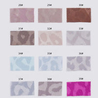 Fourteen Longan Craft Leopard Jacquard Satin fabric swatches in multicolor animal prints, numbered 28# to 39#, are arranged in two rows. These soft polyester satins feature shades of pink, brown, blue, gray, and purple—ideal for DIY shirts.