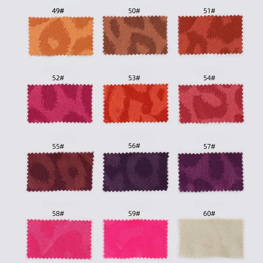Fourteen rectangular Longan Craft fabric swatches (Leopard Jacquard Satin Fabric By The Yard), numbered 49#–60#, display multicolor animal jacquard polyester satin in four rows on a white background, highlighting various colors and patterns.