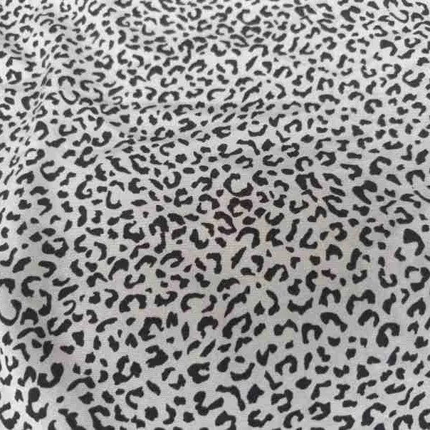 Leopard Print Chiffon Fabric By The Yard in a lightweight sheer material featuring a black leopard print pattern on a white background.