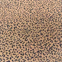 Leopard Print Chiffon Fabric By The Yard in sheer tan with a black leopard print pattern.