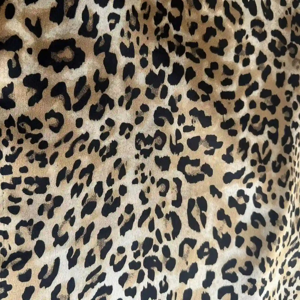 Leopard Print Chiffon Fabric By The Yard in a lightweight chiffon featuring a black and brown leopard pattern.
