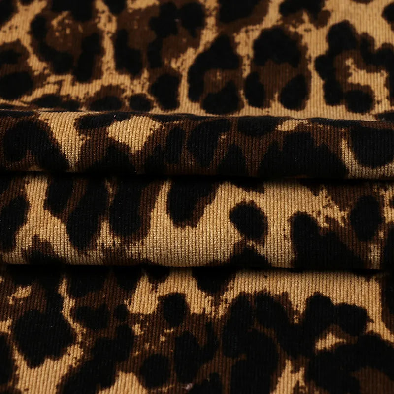 Close-up of Longan Craft's Leopard Print Corduroy Fabric By The Yard, featuring a multicolor leopard pattern and soft polyester corduroy texture—perfect, fashionable material for kids' clothing.