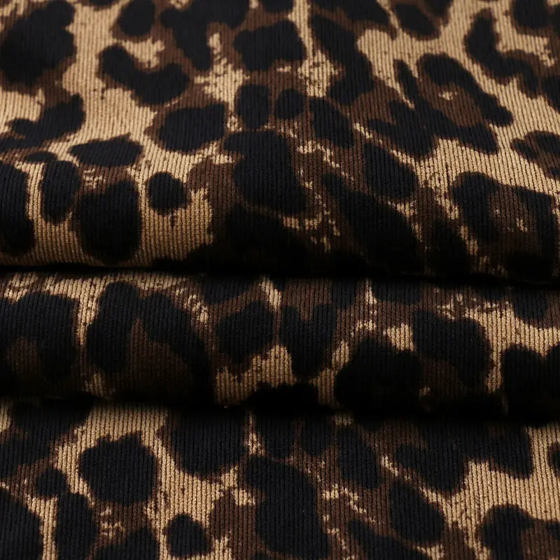 Two pieces of Longan Craft’s Leopard Print Corduroy Fabric By The Yard, stacked to showcase the multicolor leopard pattern and ribbed texture—fashionable material for kids’ clothing or creative projects.
