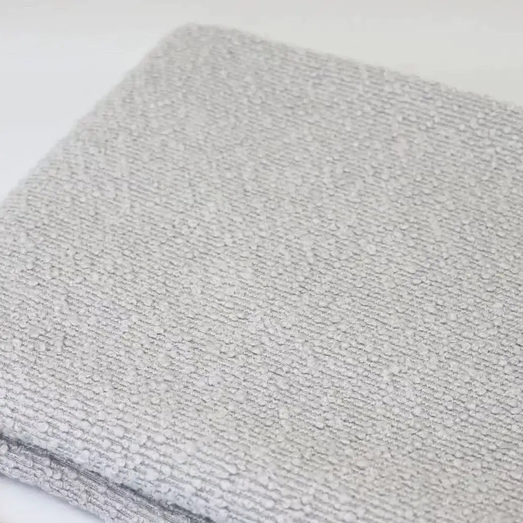 Folded light gray Linen Grain Boucle Fabric By The Yard with a textured, nubby surface.