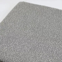 A close-up of grey textured Linen Grain Boucle Fabric By The Yard upholstery.