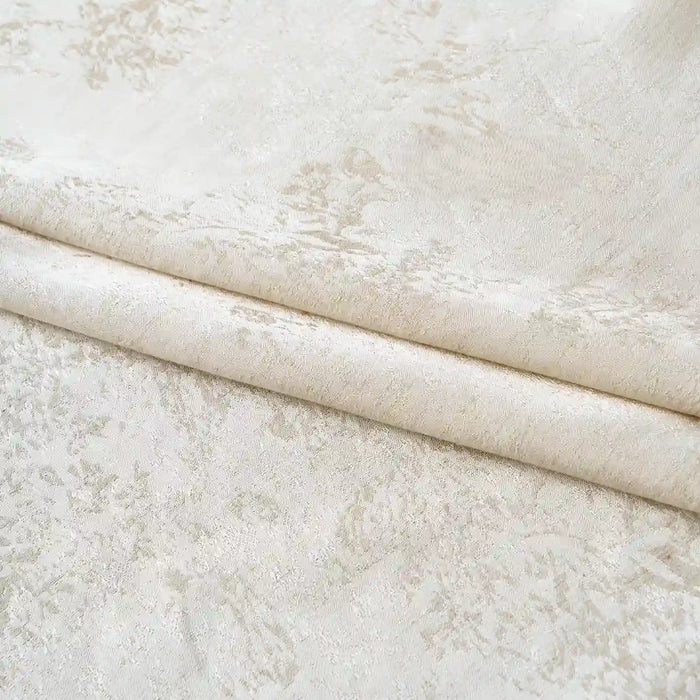 The Longan Craft Linen Viscose Jacquard Satin Fabric By The Yard features a light beige shade and a subtle, intricate floral pattern. Displayed neatly folded, this luxury rayon satin material showcases a soft texture with a gentle sheen, highlighting the delicate jacquard design—making it an elegant choice for dresses and special projects.