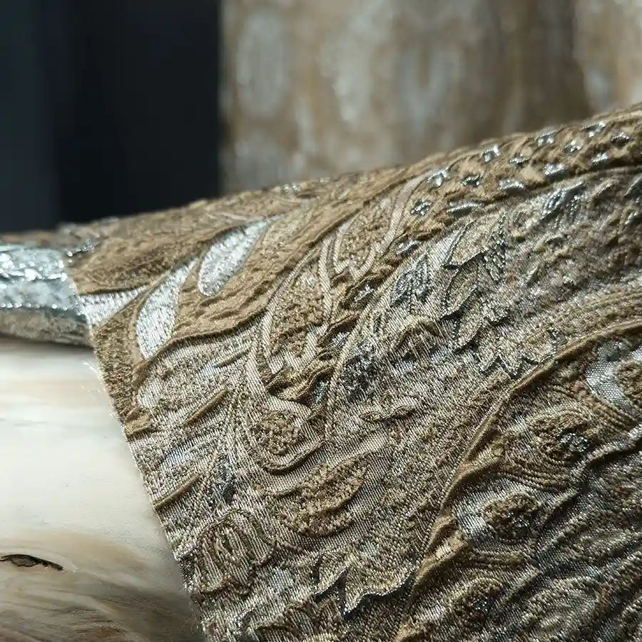 Close-up of Longan Craft’s Luxury Embossed Brocade Fabric By The Yard, a metallic Jacquard brocade with ornate gold and silver floral patterns, elegantly draped for premium dressmaking.