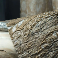 Close-up of Longan Craft’s Luxury Embossed Brocade Fabric By The Yard, a metallic Jacquard brocade with ornate gold and silver floral patterns, elegantly draped for premium dressmaking.