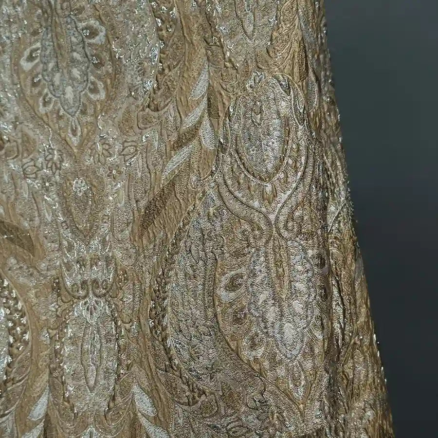 Close-up of Longan Craft Luxury Embossed Brocade Fabric by the Yard, a premium metallic jacquard featuring intricate gold and silver paisley and floral patterns with shimmering threads, ideal for elegant dress projects.