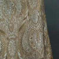 Close-up of Longan Craft Luxury Embossed Brocade Fabric by the Yard, a premium metallic jacquard featuring intricate gold and silver paisley and floral patterns with shimmering threads, ideal for elegant dress projects.