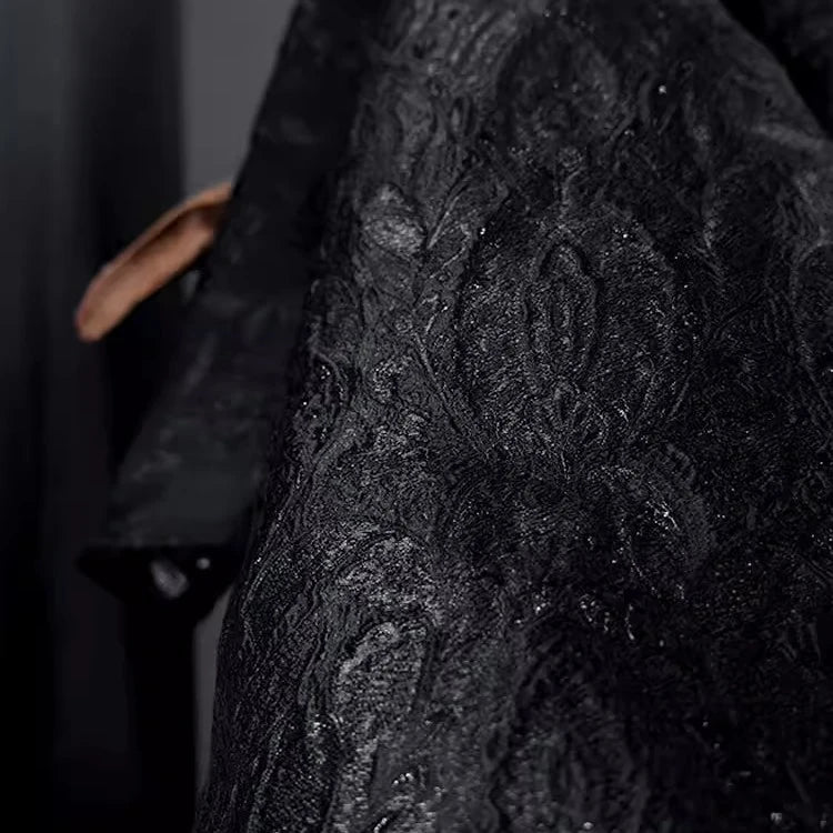 Close-up of Longan Craft’s Luxury Embossed Metallic Jacquard Brocade Fabric by the yard, featuring a subtle ornate pattern and elegant sheen, partially draped with a hand holding the edge in the background.