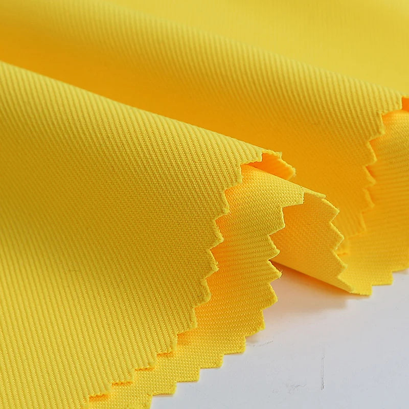 Longan Craft's Matte Finish Gabardine Fabric By The Yard is shown in neat folds with zigzag, pinked edges to prevent fraying. This high-quality, single-color twill weave textile is displayed on a white background—perfect for jackets.