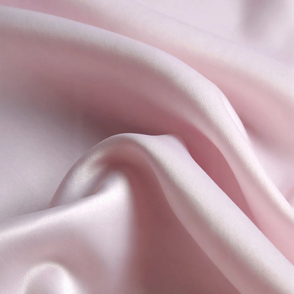 Longan Craft's Matte Satin Fabric By The Yard features a soft, light pink polyester with a smooth, elegant texture and subtle sheen—ideal for comfortable bridesmaid or wedding dresses.