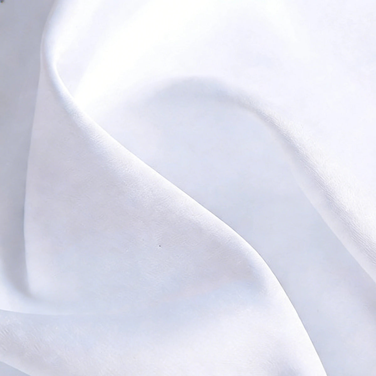 A close-up of Longan Craft Matte Satin Fabric By The Yard reveals its smooth, subtle sheen and gentle folds—ideal for elegant bridesmaid dresses and perfect for comfortable, stylish dressmaking projects.