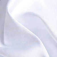 A close-up of Longan Craft Matte Satin Fabric By The Yard reveals its smooth, subtle sheen and gentle folds—ideal for elegant bridesmaid dresses and perfect for comfortable, stylish dressmaking projects.
