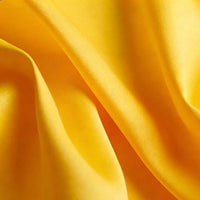 Close-up of Longan Craft Matte Satin Fabric By The Yard, featuring a bright yellow solid color with smooth texture and gentle folds—ideal, comfortable satin textile for bridesmaid dresses.