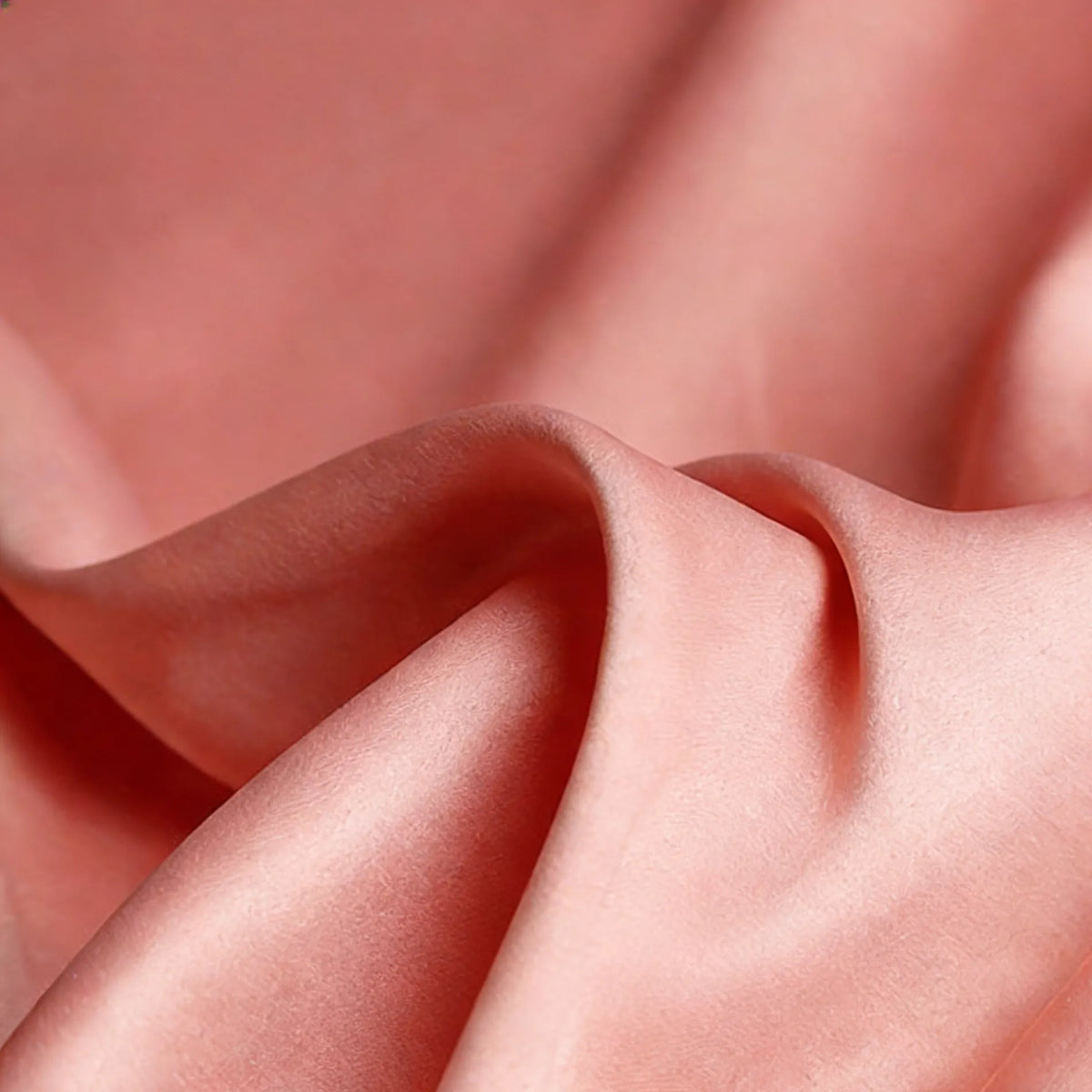 Close-up of Longan Craft Matte Satin Fabric By The Yard—solid color, smooth and soft with gentle folds—comfortable satin textile ideal for elegant bridesmaid dresses and wedding attire.