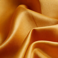 Close-up of Longan Craft Matte Satin Fabric By The Yard in solid golden-yellow, featuring soft folds and a smooth, satin texture—ideal for comfortable and elegant bridesmaid dresses.