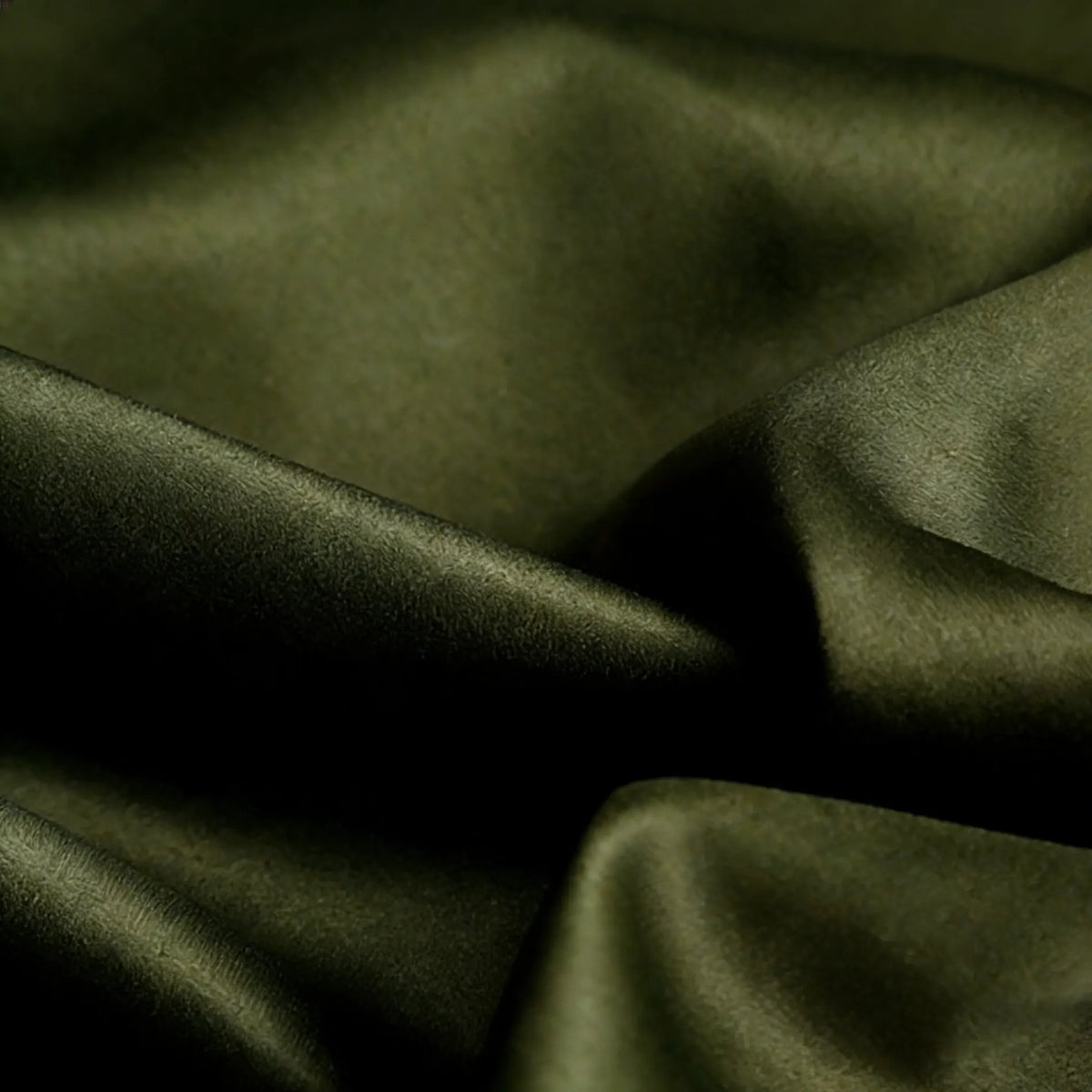 Close-up of Longan Craft Matte Satin Fabric By The Yard in dark olive green, showing gentle folds and a subtle sheen—ideal for solid color bridesmaid dresses and comfortable satin textiles.