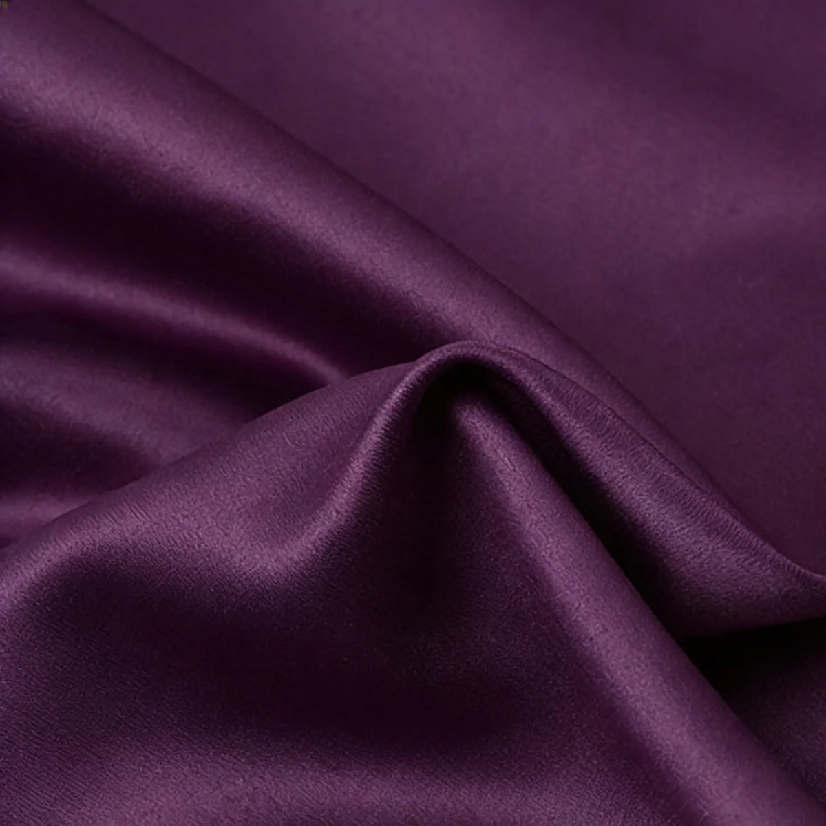 A close-up of Longan Craft Matte Satin Fabric By The Yard shows smooth, gentle folds and a silky texture—ideal for comfortable solid color bridesmaid dresses.