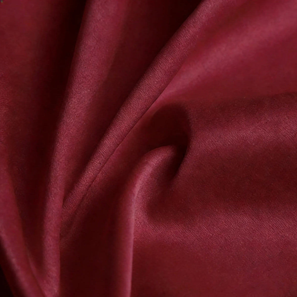 A close-up of Longan Craft Matte Satin Fabric By The Yard in deep red, showing its soft, velvety texture and gentle folds—perfect for bridesmaid dresses and comfortable satin textiles.
