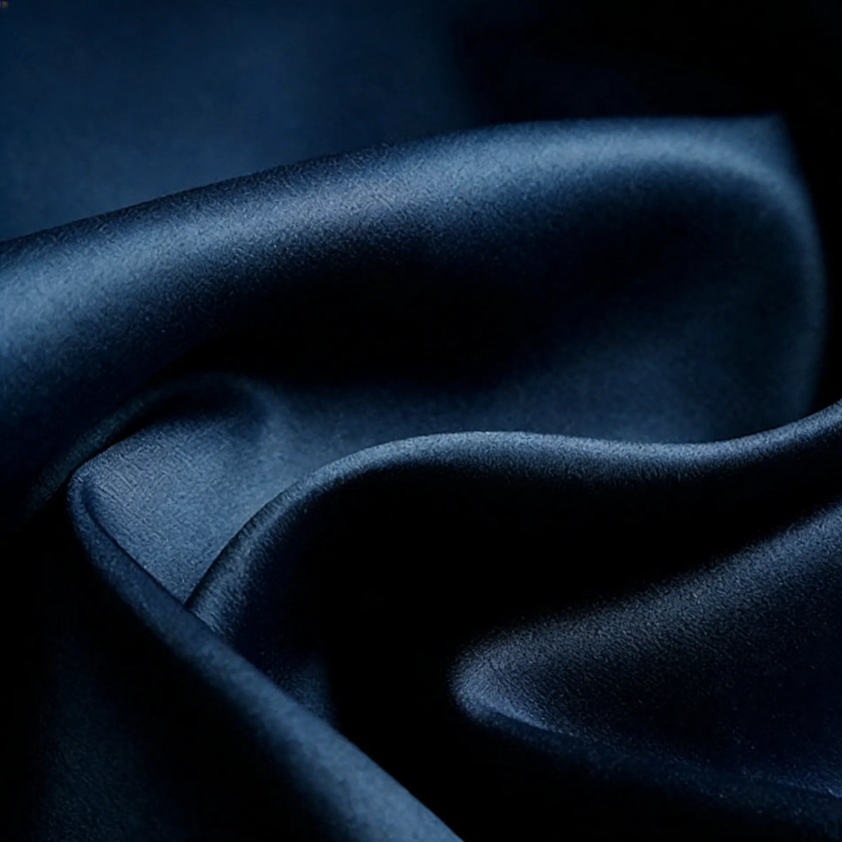 A close-up of Longan Craft Matte Satin Fabric by the Yard, showing its smooth folds and gentle sheen, highlights the solid color and satin texture—ideal for comfortable bridesmaid dresses.